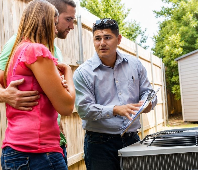 AC repair technician discussing air conditioning issues with homeowners in Lakeland