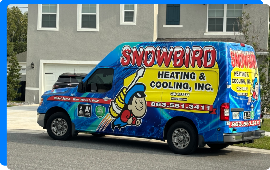 A work van from Snowbird parked in front of a residential home