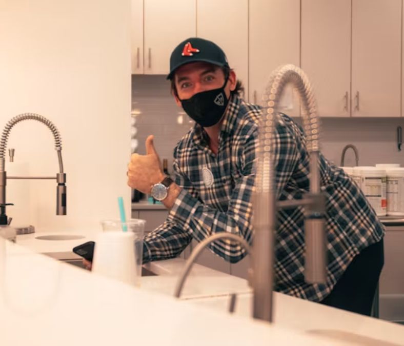 Plumber inspecting residential plumbing connections