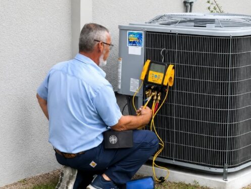 Technician measuring refrigerant levels during an air conditioning repair in Lakeland